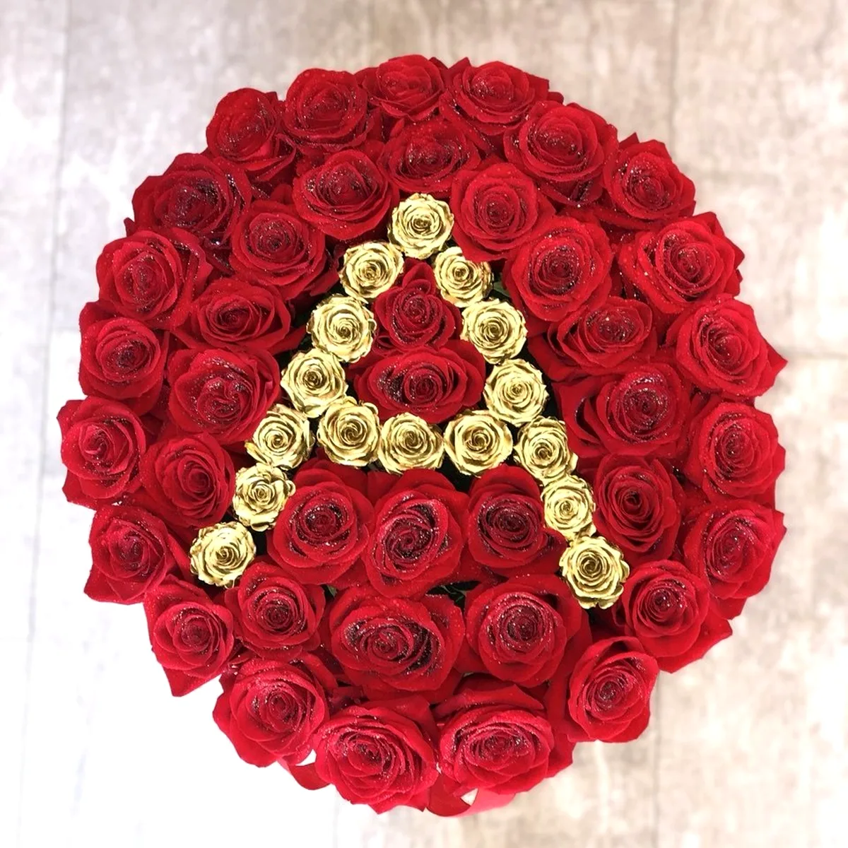 Initial A in gold roses